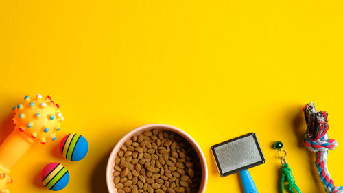 Close-up of multi colored pencils on table against yellow background