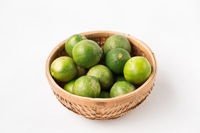 Close-up of fruits in basket on white background