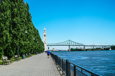 Bridge over river against blue sky