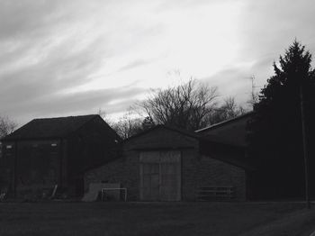 Houses against cloudy sky