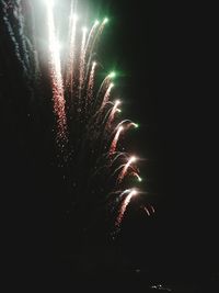 Low angle view of firework display at night