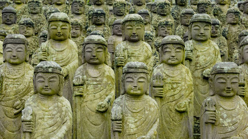 Statue of buddha in row