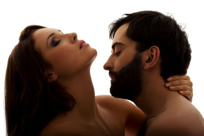 Portrait of young couple against white background
