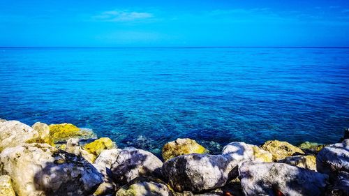 Scenic view of sea against blue sky