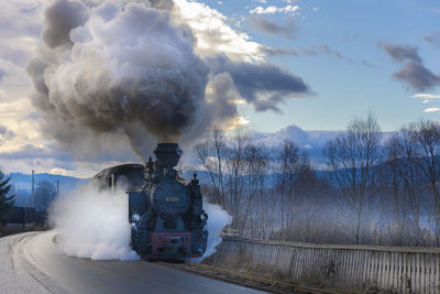 Rear view of man standing on railroad track