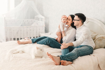 Young couple kissing on bed at home