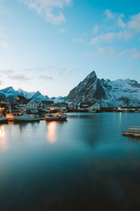 Scenic view of lake with snowcapped mountain in background