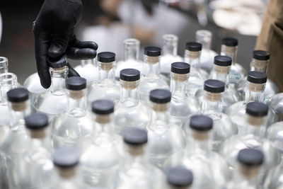 Bottles of liquor being capped at a distillery.