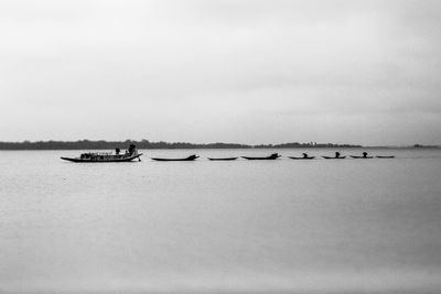 Boat sailing on sea against sky