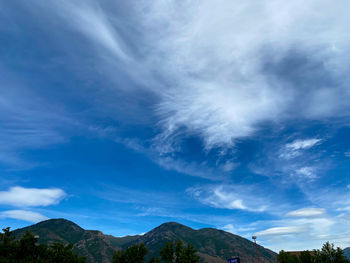 Low angle view of mountains against blue sky