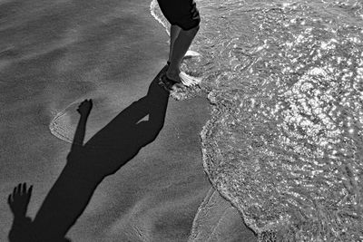 Low section of woman walking on road