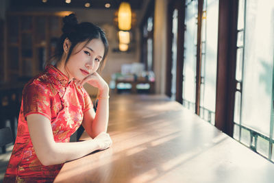 Portrait of woman sitting at table