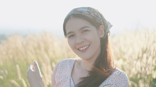 Portrait of smiling young woman on field