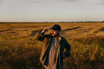 Portrait of a man in a field at sunset