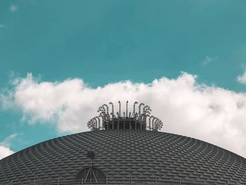 Low angle view of modern building against cloudy sky