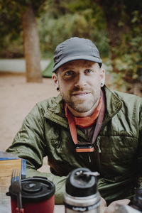 Portrait of man sitting at table in forest