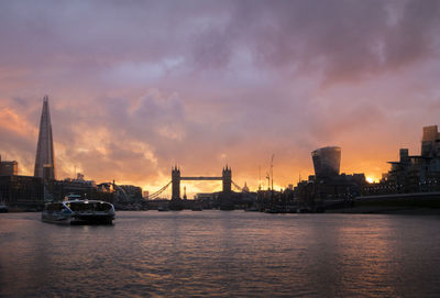 Sunset over tower bridge and the shard in london, uk, taken from the river thames