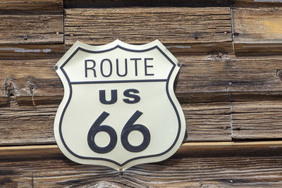 Close-up of text on wooden wall