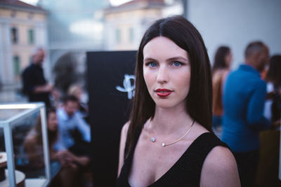 Portrait of young woman standing outdoors