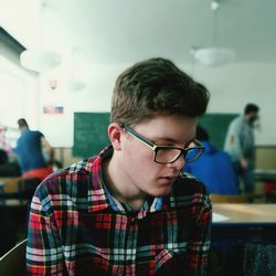 Young male student sitting in classroom