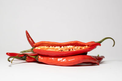 Close-up of red chili pepper against white background