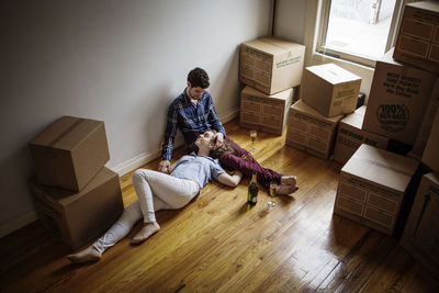 High angle view of couple relaxing on floor at home