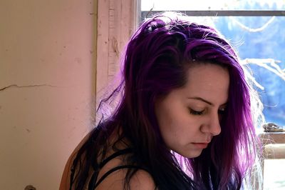 Portrait of beautiful woman at window