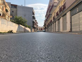 Surface level of road amidst buildings in city