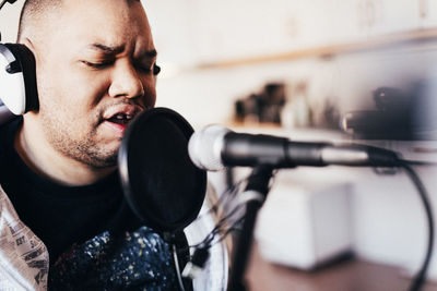 Disabled male singer singing in recording studio