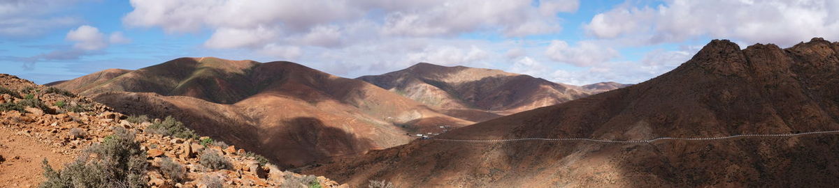 Panoramic view of mountains against cloudy sky