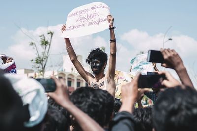 Man holding sign in street protest