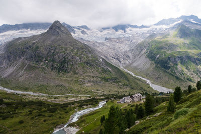 Scenic view of mountains against sky with glacier in background