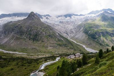 View on alpine mountain range with a glacier in background including the mountain hut berliner hütte