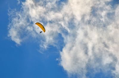 Low angle view of parachute flying in sky