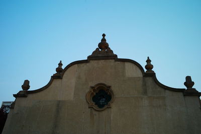 Low angle view of building against clear blue sky