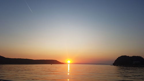 Scenic view of sea against clear sky during sunset