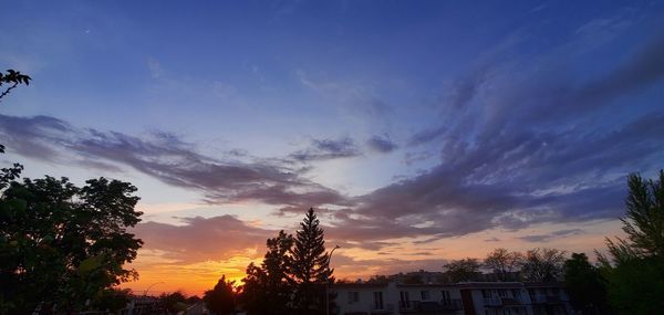 Low angle view of silhouette buildings against sky during sunset