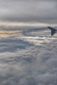 Aerial view of cloudscape over airplane wing