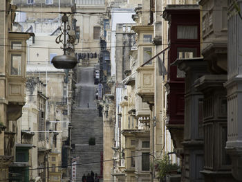 Low angle view of street light against buildings in town