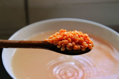 High angle view of lentils on wooden spoon