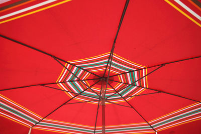 Low angle view of red parasol