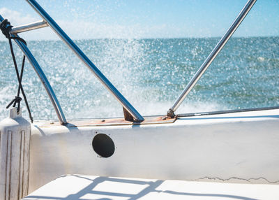 Water splashing in boat on sunny day