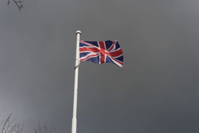 Low angle view of flag against sky