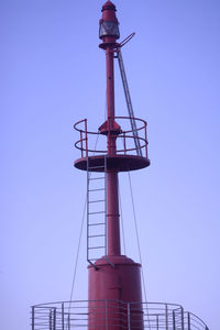 Low angle view of crane against clear blue sky