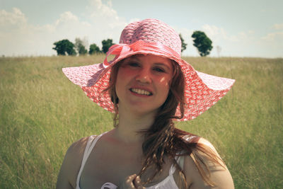 Portrait of woman wearing hat on agricultural field 