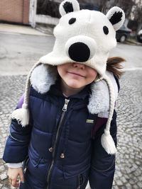 Girl wearing polar bear shape knit hat on street