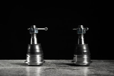 Close-up of chess pieces on board against black background