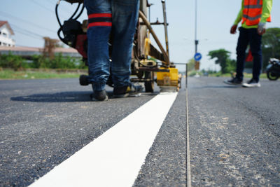 Low section of people walking on road