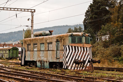 Abandoned train on railroad track against sky