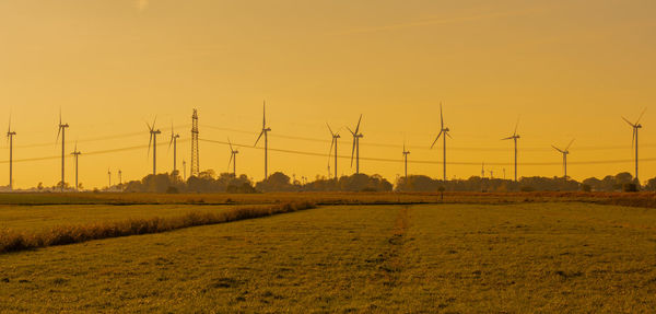 Wind turbines onshore wind farm on the north sea coast at sunset